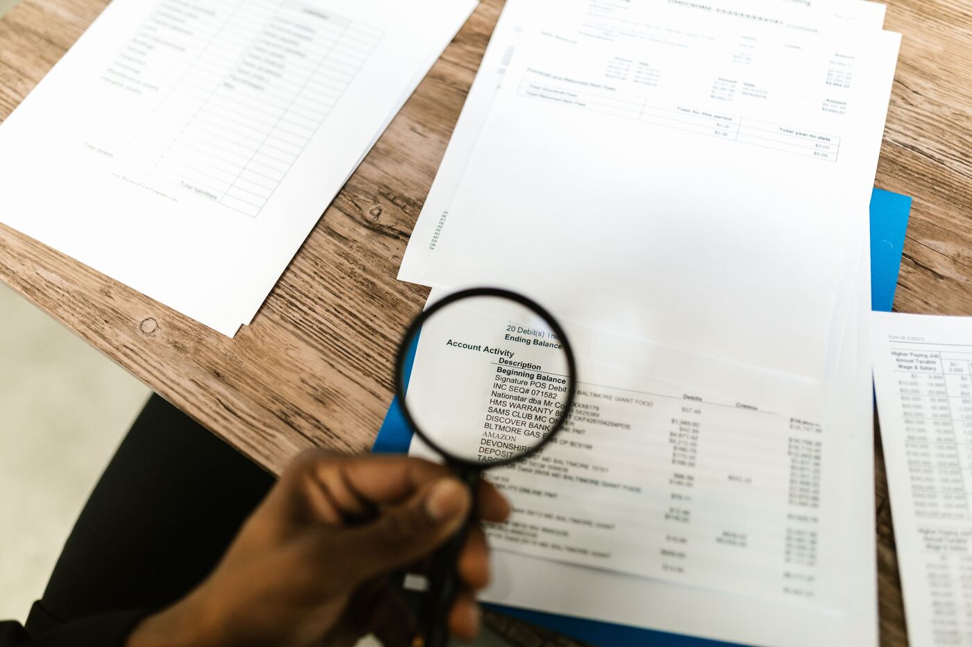 Reviewing a financial statement closely with a magnifying glass